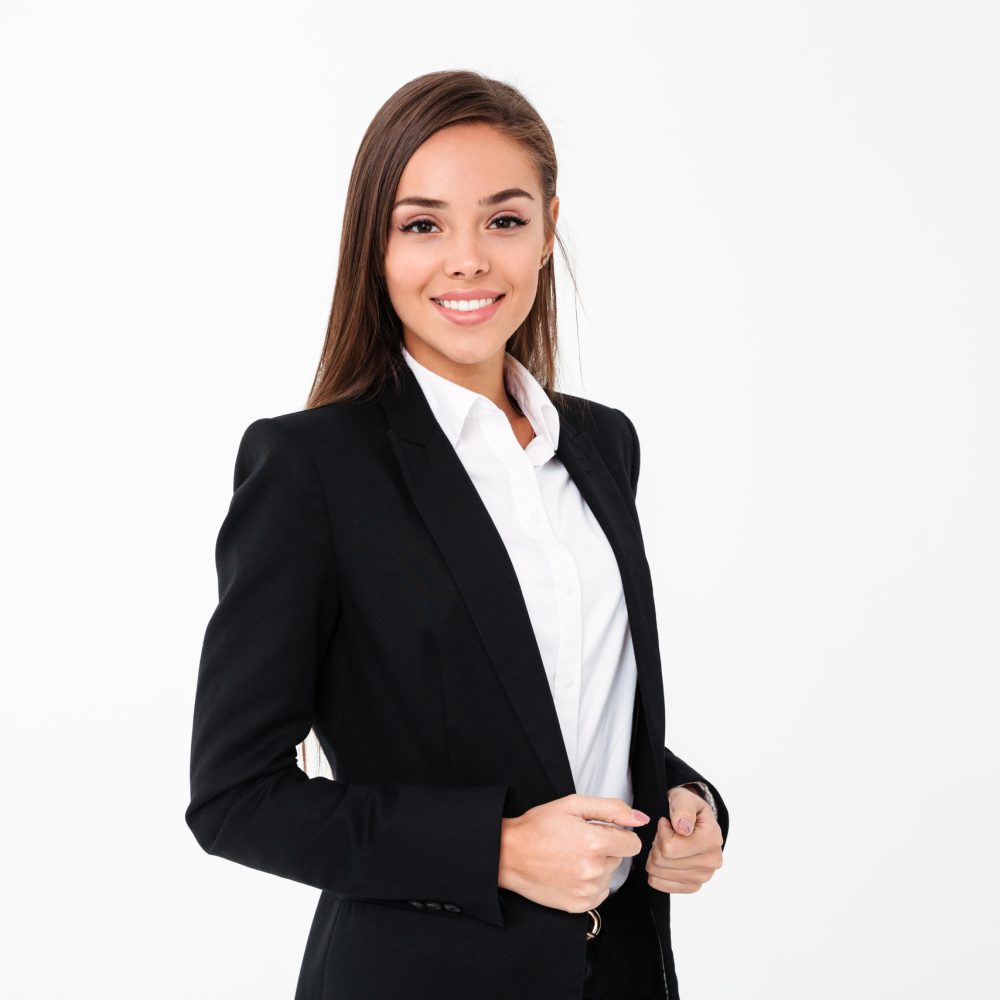 Picture of gorgeous cheerful business woman standing isolated over white background. Looking camera.